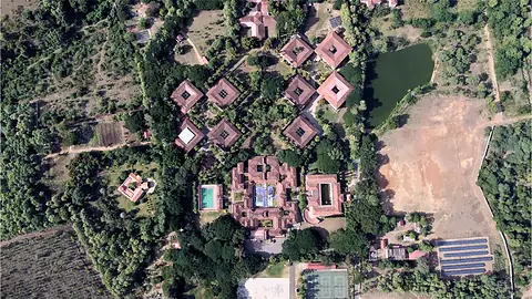 An overhead view of buildings surrounded by trees