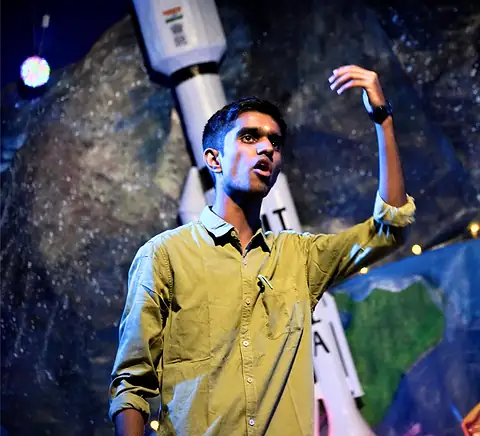 A performer under blue stage lights