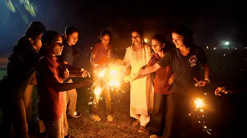 Students lighting sparklers on Diwali night