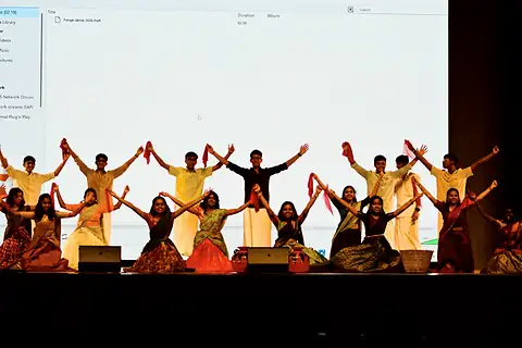 Students performing a dance on stage at the Pongal cultural programme
