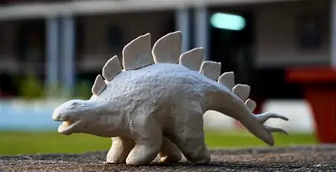 Photograph of a white clay stegosaurus on a ledge
The Crossroads, Issue 14 · January–February 2024