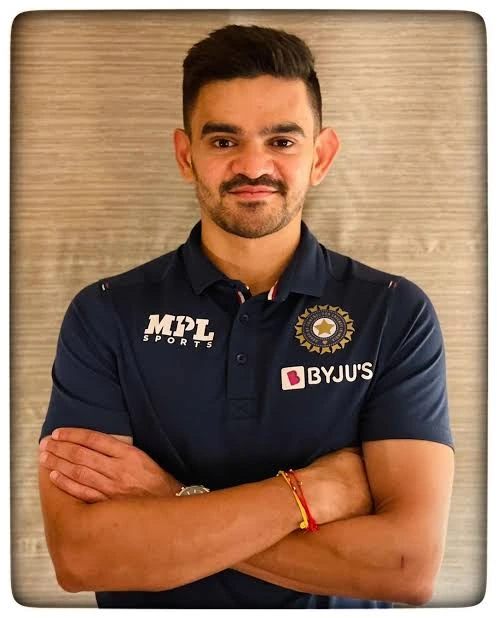 Soham Desai standing with his arms folded in a navy sports shirt.