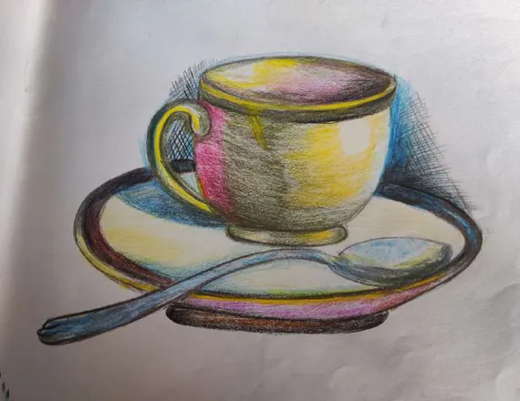 A teacup and saucer with a spoon, in soft pinks, yellows and blues