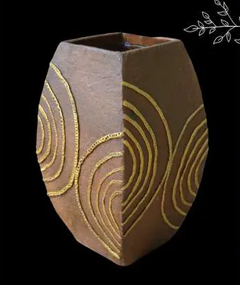 A brown vase with raised gold swirls