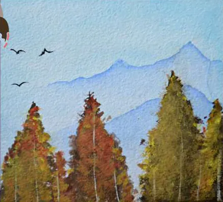 Autumn trees in orange and gold beneath pale blue mountains