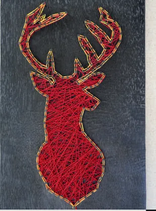 A stag's head in red thread strung between pins on a dark board