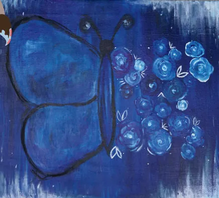 A deep blue butterfly beside a cluster of blue roses