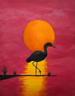 A heron silhouetted against an orange sun on a red sky