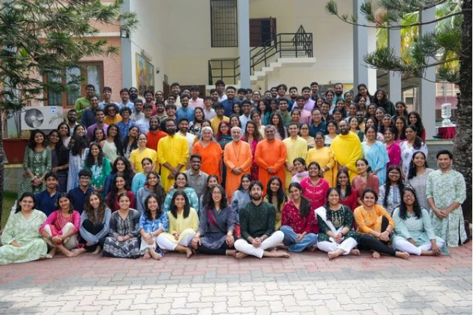 Large group posed together outside a building