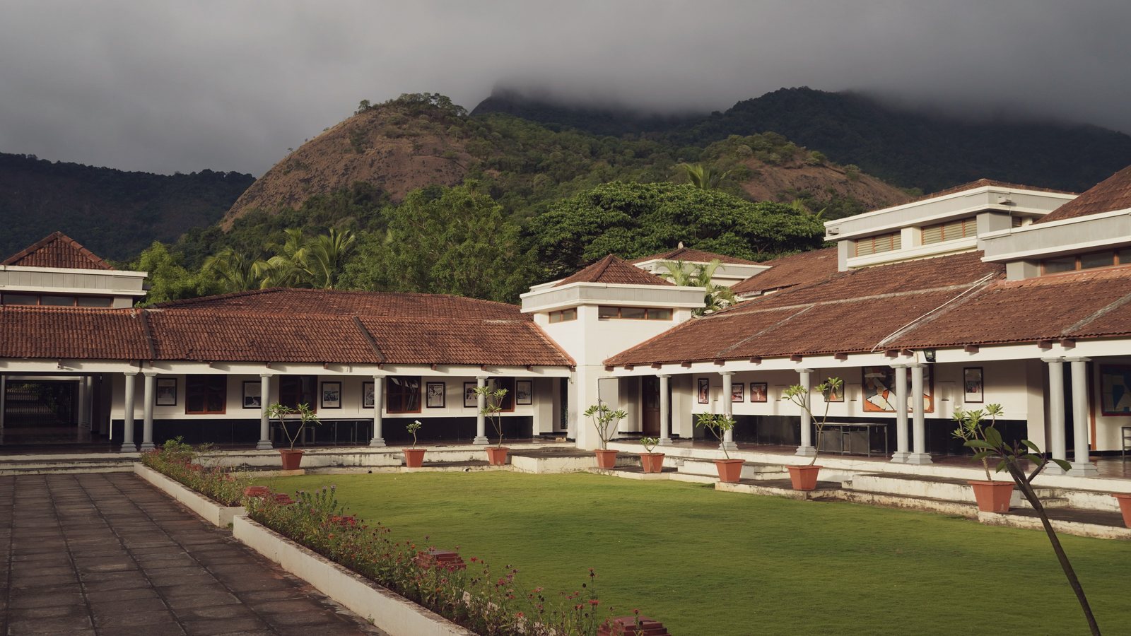 CIRS academic buildings and lawn beneath the Siruvani hills