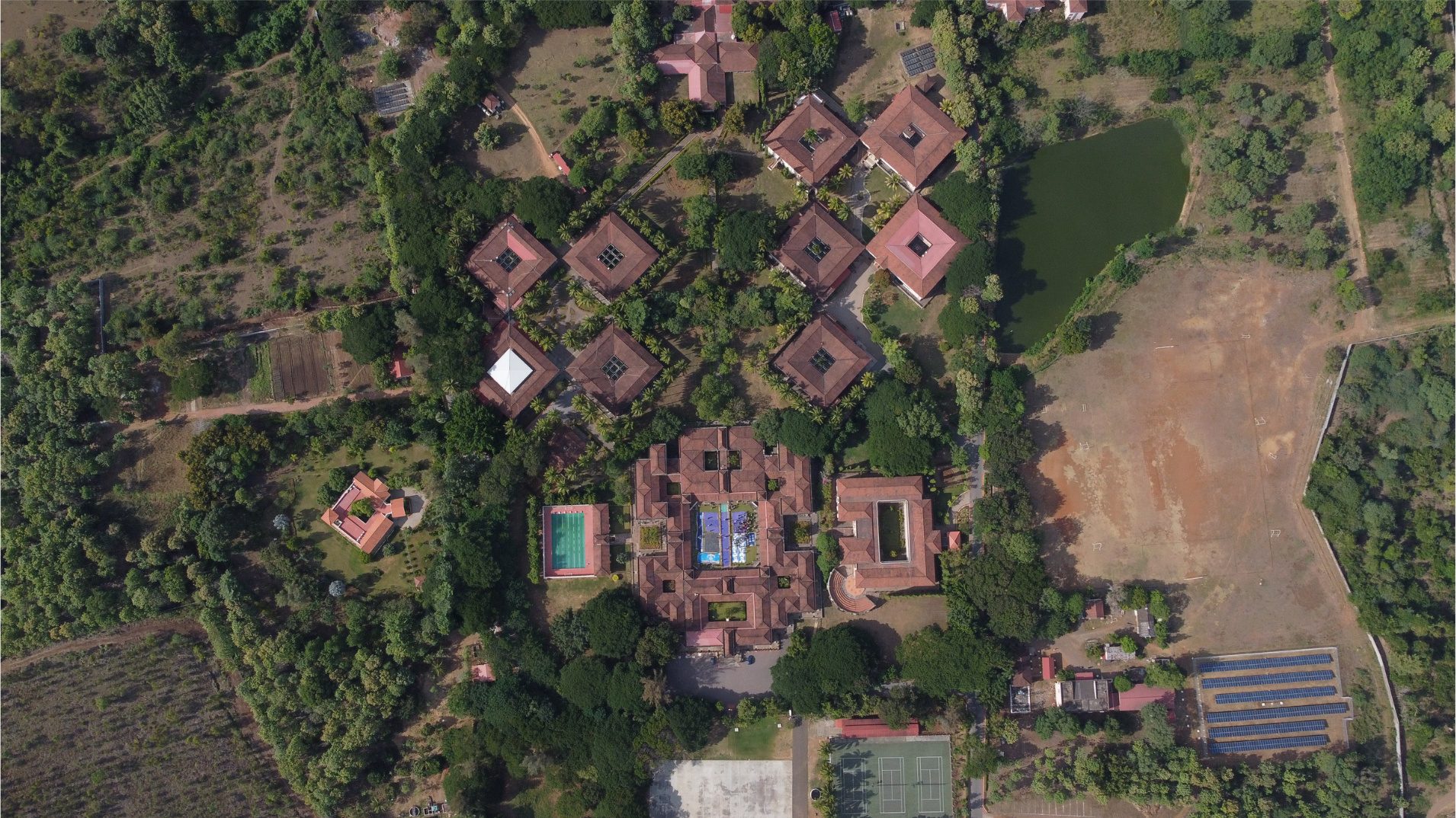 An overhead view of buildings surrounded by trees