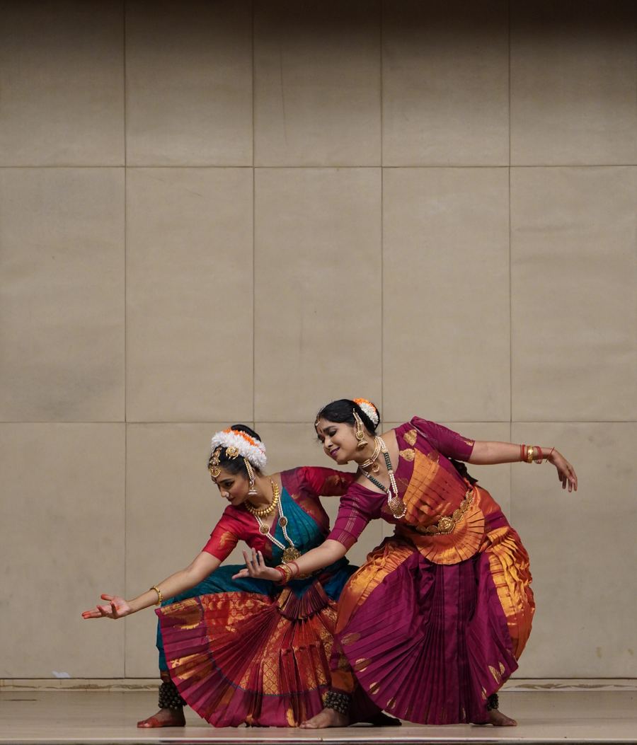 Two performers dancing in colorful dress