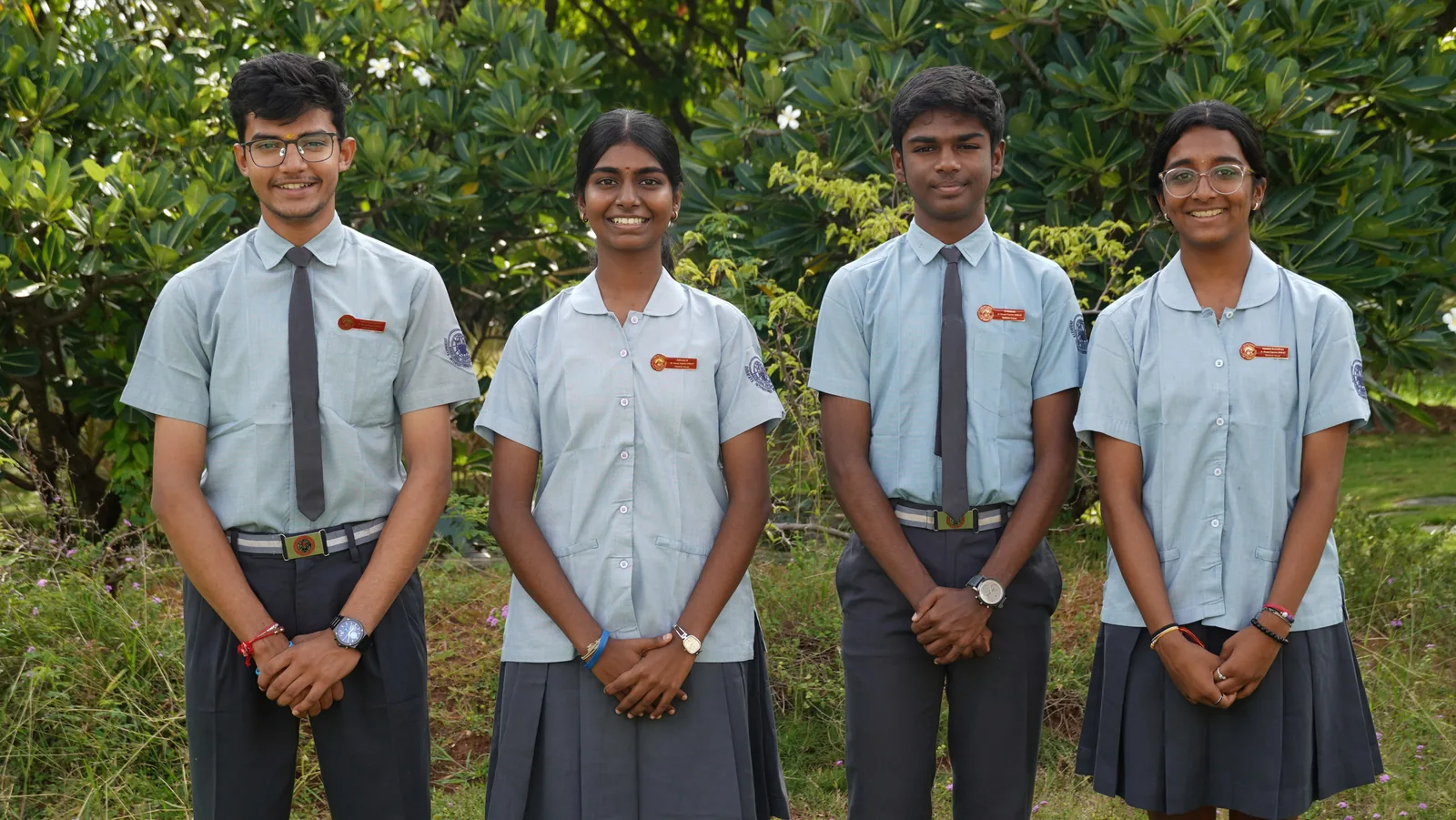 The four Vasishta House Captains of the Student Council 2026–27 standing in a row before green shrubs