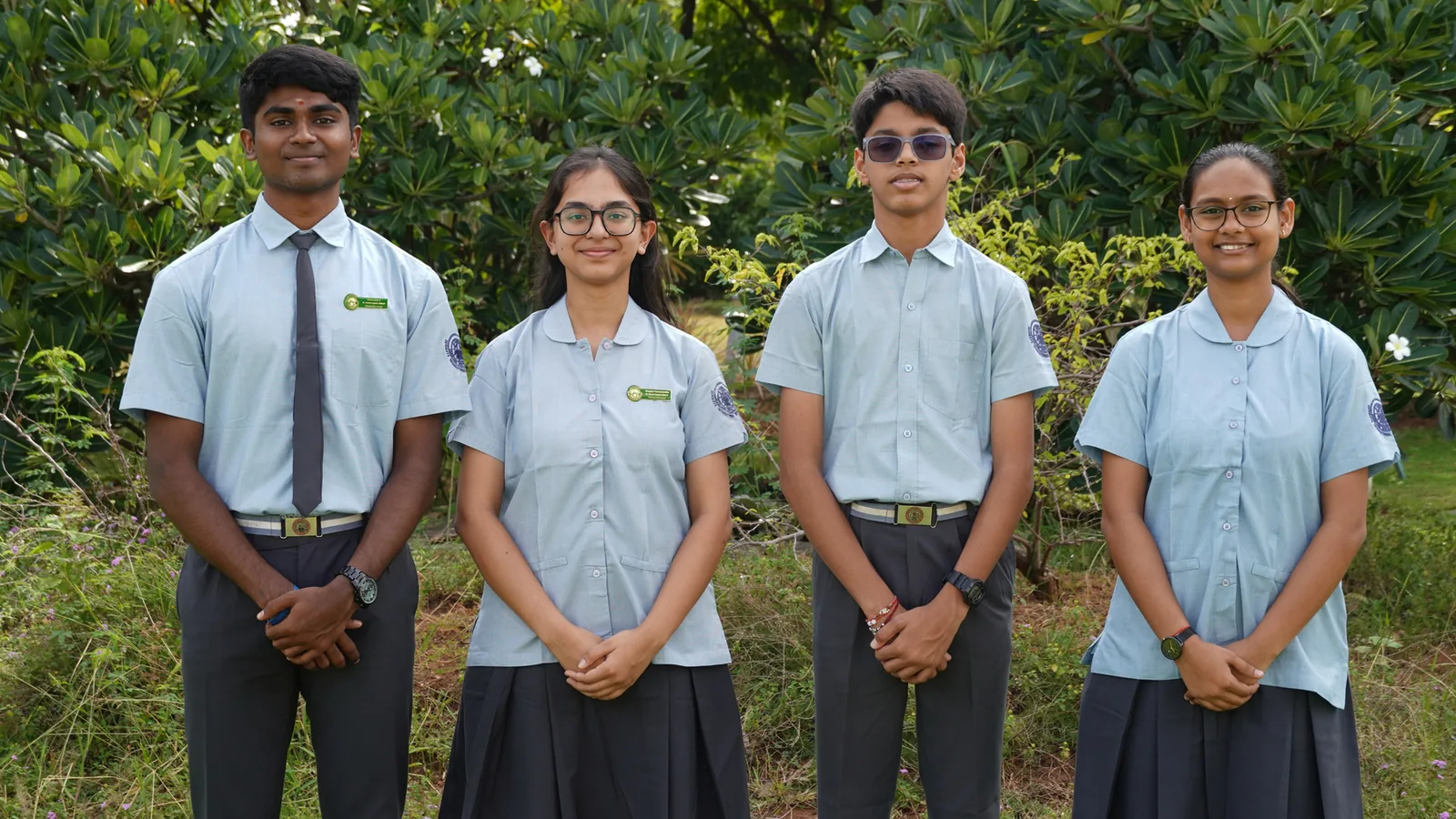 The four Vishwamitra House Captains of the Student Council 2026–27 standing in a row before green shrubs