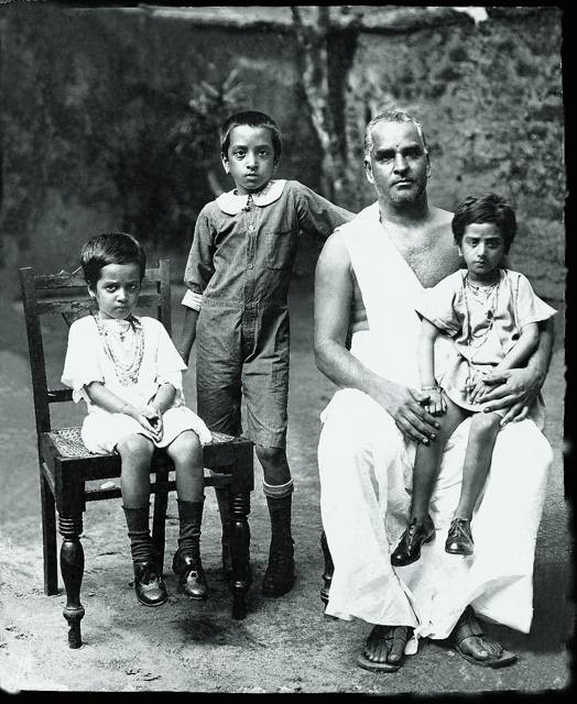 One adult and three children in an archival group portrait.