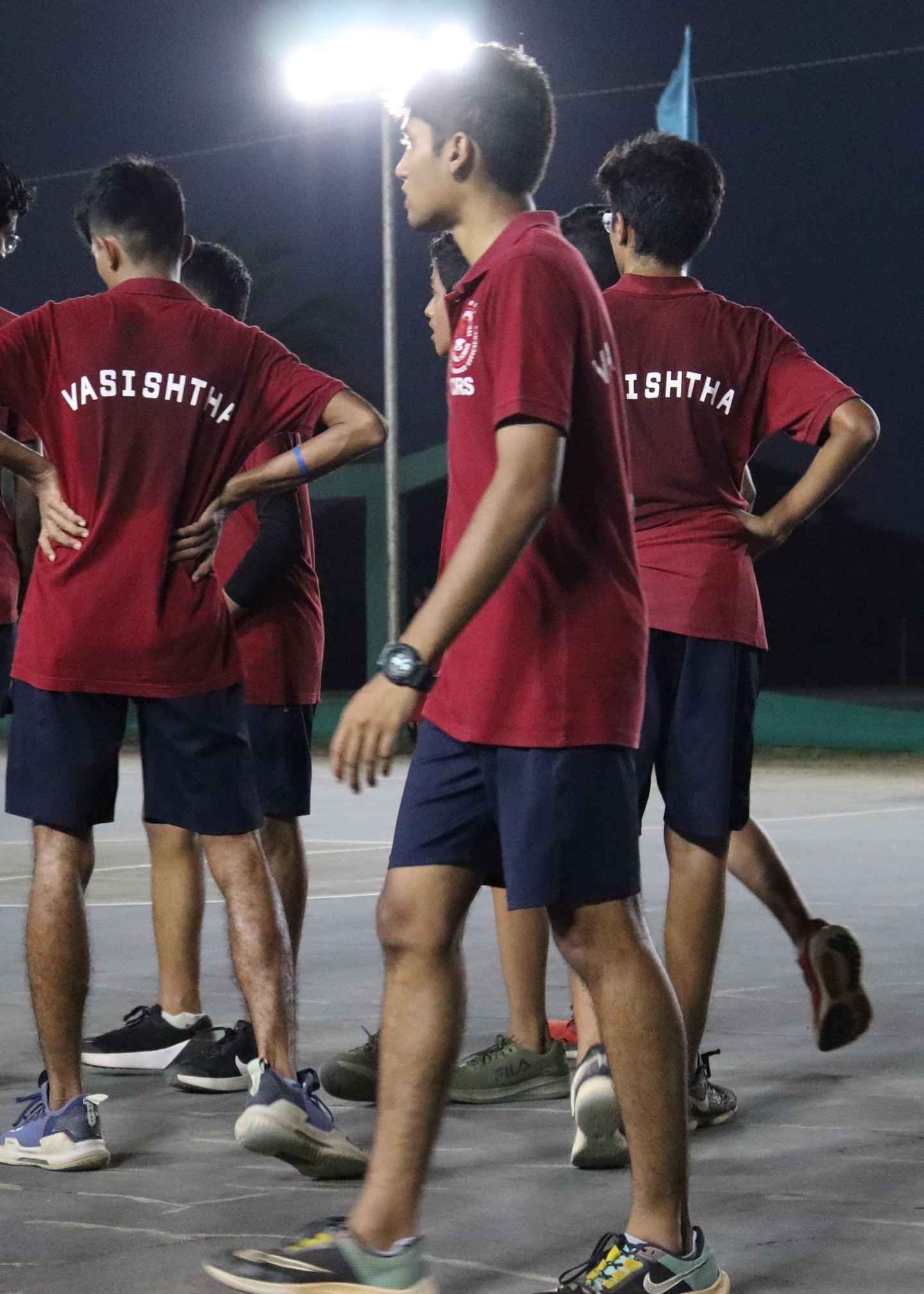 Vasishta basketball players in red shirts bearing the house name