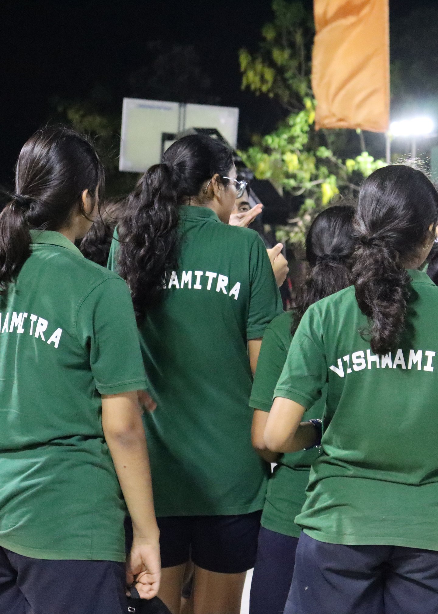 Vishwamitra students gathered on the basketball court, their house name visible across green shirts