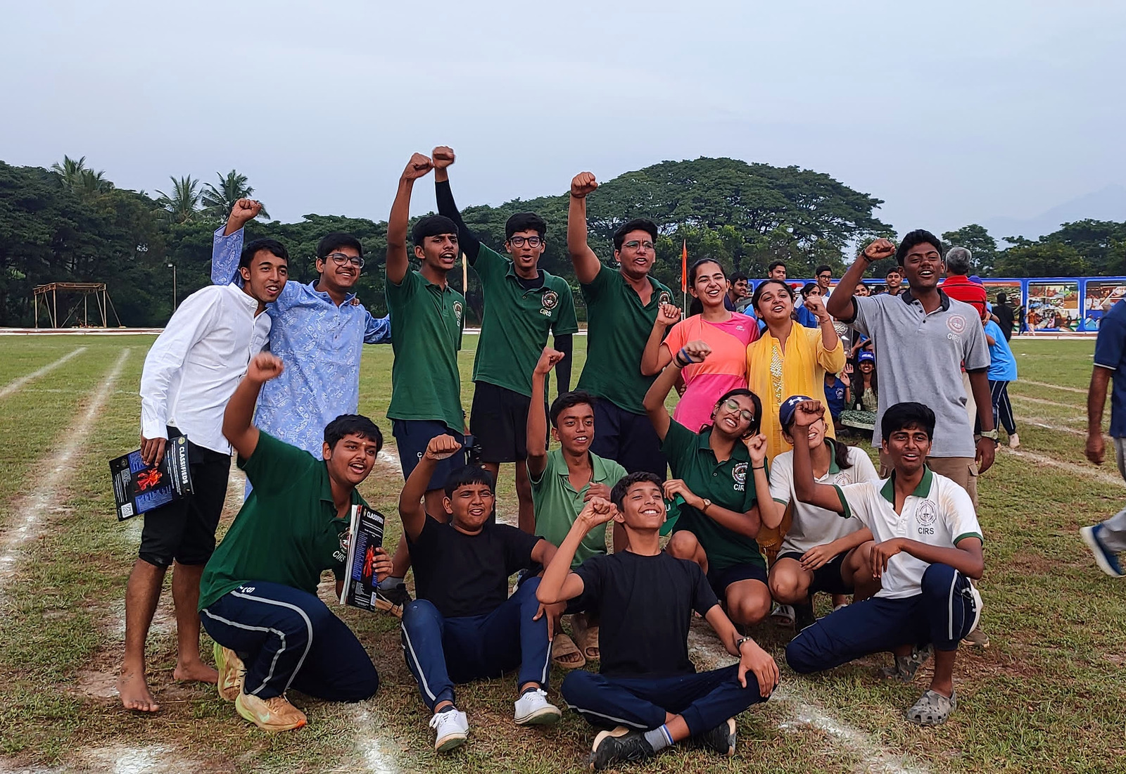Vishwamitra students gathered on the field beside the Khel Mela 2024 banner
