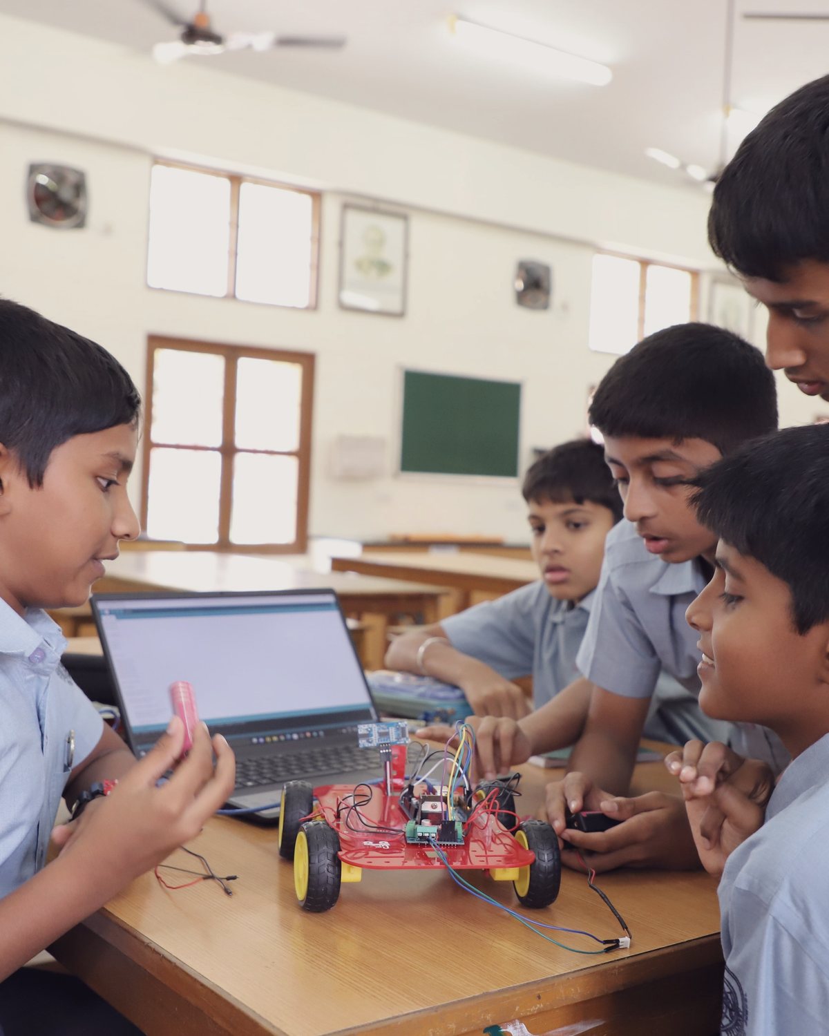 Junior School students building a wheeled robot