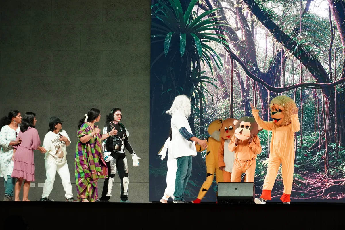 CIRS teachers in costume performing a skit before a jungle backdrop on Children's Day
