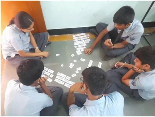 Grade 10 students matching Samas and Vigraha word cards on the classroom floor