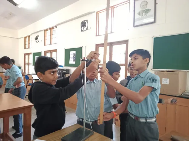 Grade 7 students measuring the period of a simple pendulum