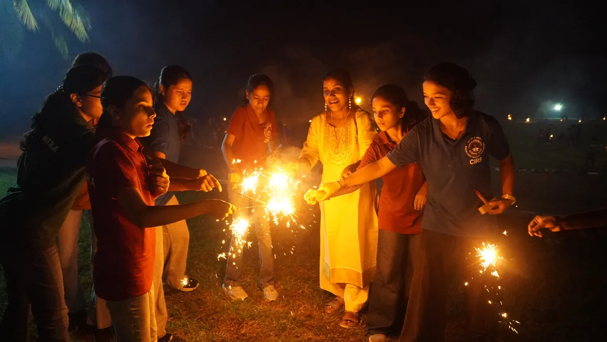 Students lighting sparklers on Diwali night