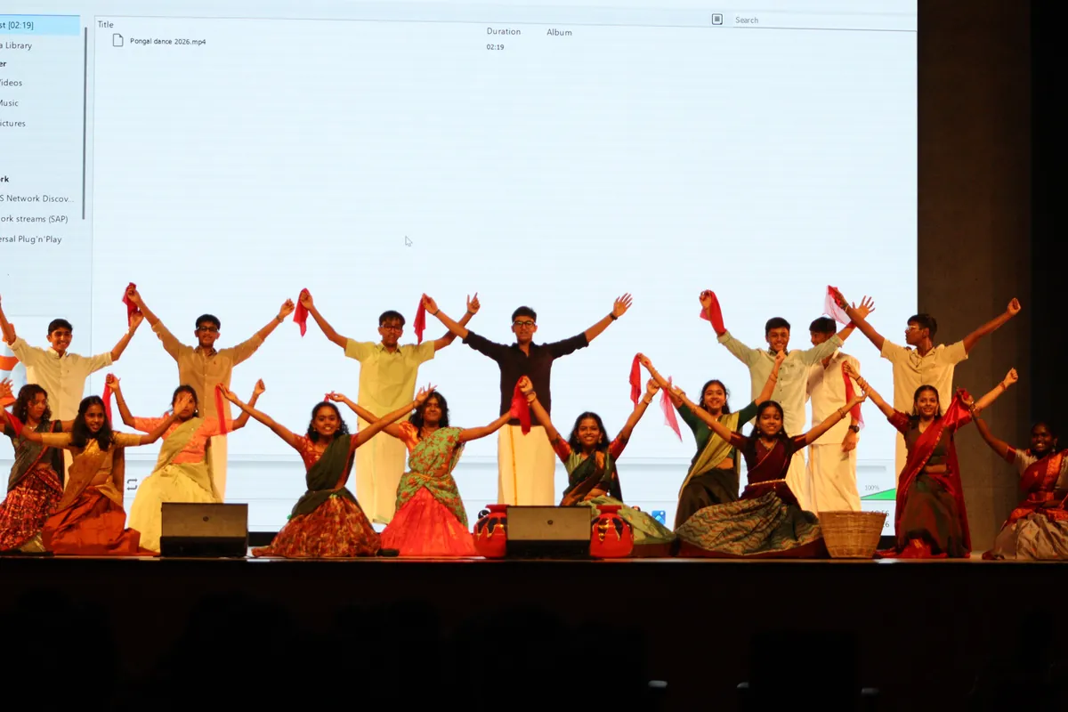 Students performing a dance on stage at the Pongal cultural programme