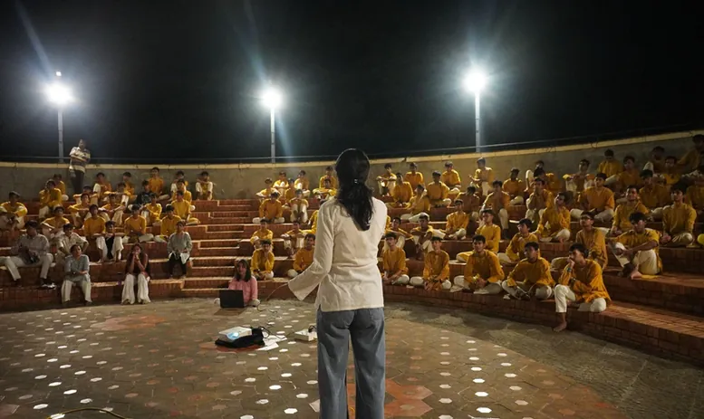 A YEI student presenting the Union Budget to Grades 11 and 12 in the open-air amphitheatre