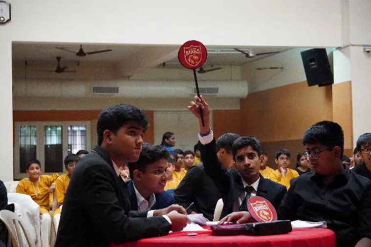 Students bidding with paddles at the IPL Auction simulation