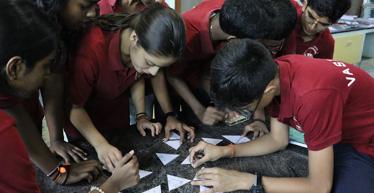 CIRS students working together on a tabletop mathematics challenge