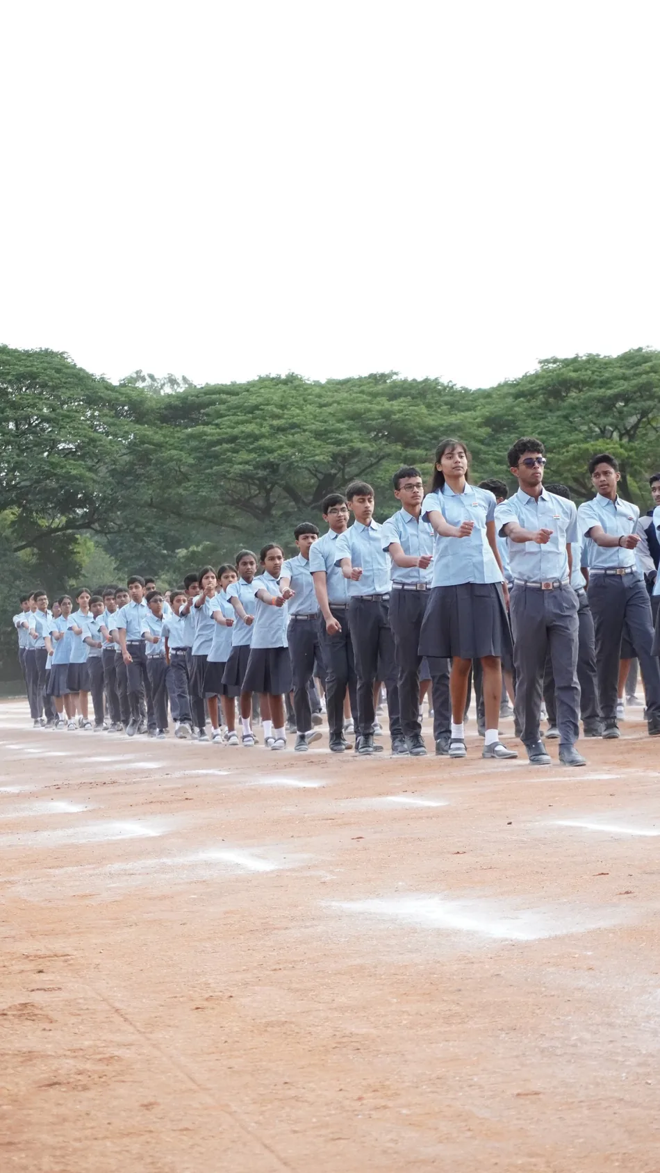 Rows of students standing in formation on a parade ground