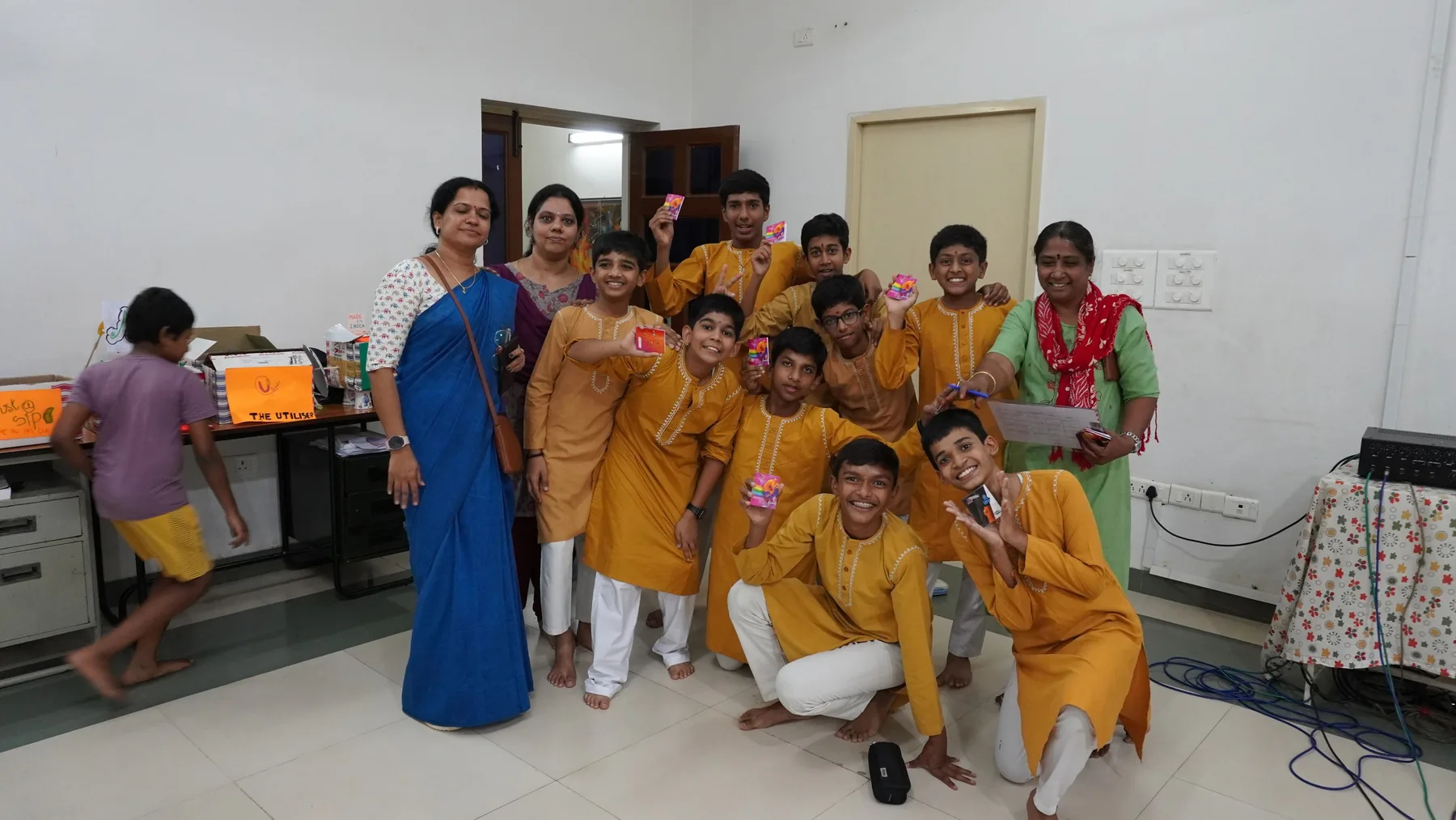 Students in mustard kurtas and teachers gathered in a laboratory