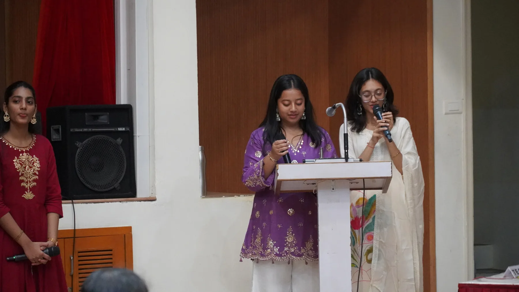 Two women speaking at a lectern