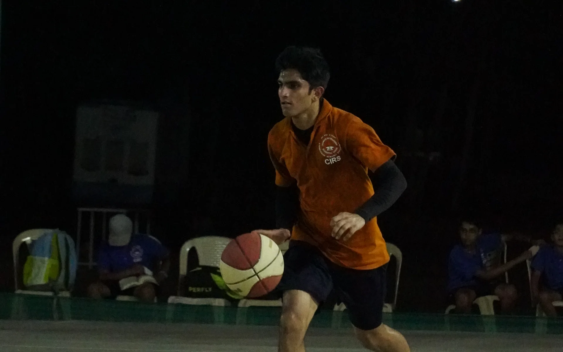 A CIRS student drives forward with the basketball