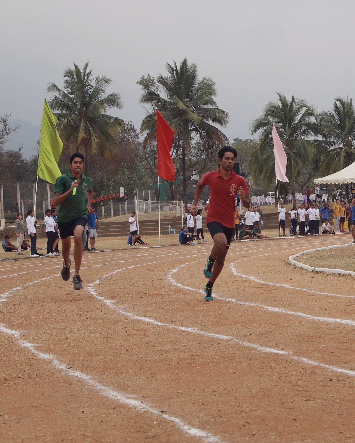 Runners rounding the track during an athletics meet at CIRS