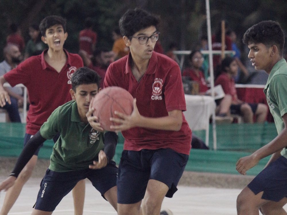 Intense basketball contest under defensive pressure at CIRS