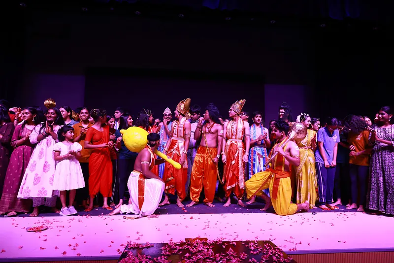 The cast crowded together on the stage at the close, petals on the floor